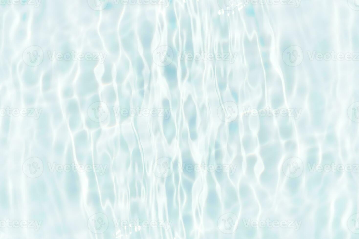 Defocus blurred transparent blue colored clear calm water surface texture with splashes and bubbles. Trendy abstract nature background. Water waves in sunlight with copy space. Blue watercolor shining photo