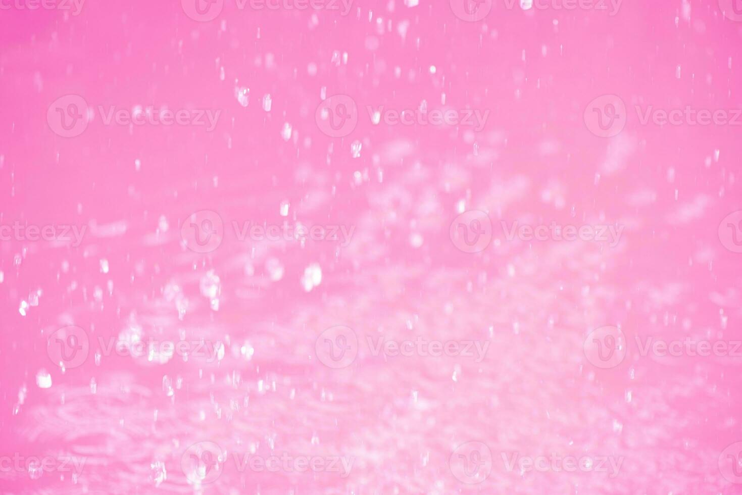 Purple water waves on the surface ripples blur. Defocus blurred transparent pink colored clear calm water surface texture with splash and bubbles. Water waves with shining pattern texture background. photo