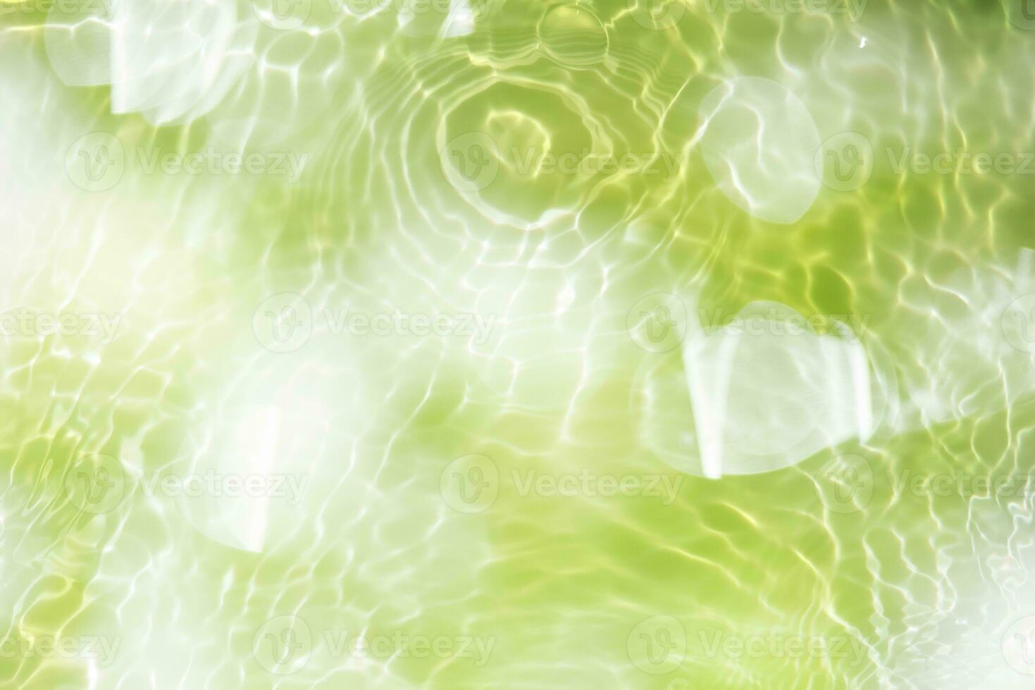 Defocus blurred transparent blue colored clear calm water surface texture with splashes and bubbles. Trendy abstract nature background. Water waves in sunlight with copy space. Blue watercolor shining photo