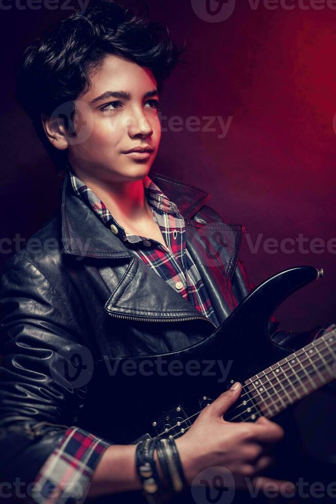 Handsome guy playing on guitar photo