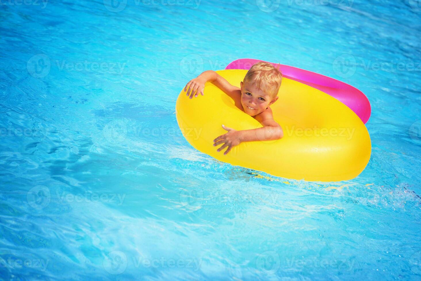 Happy boy in swimming pool photo