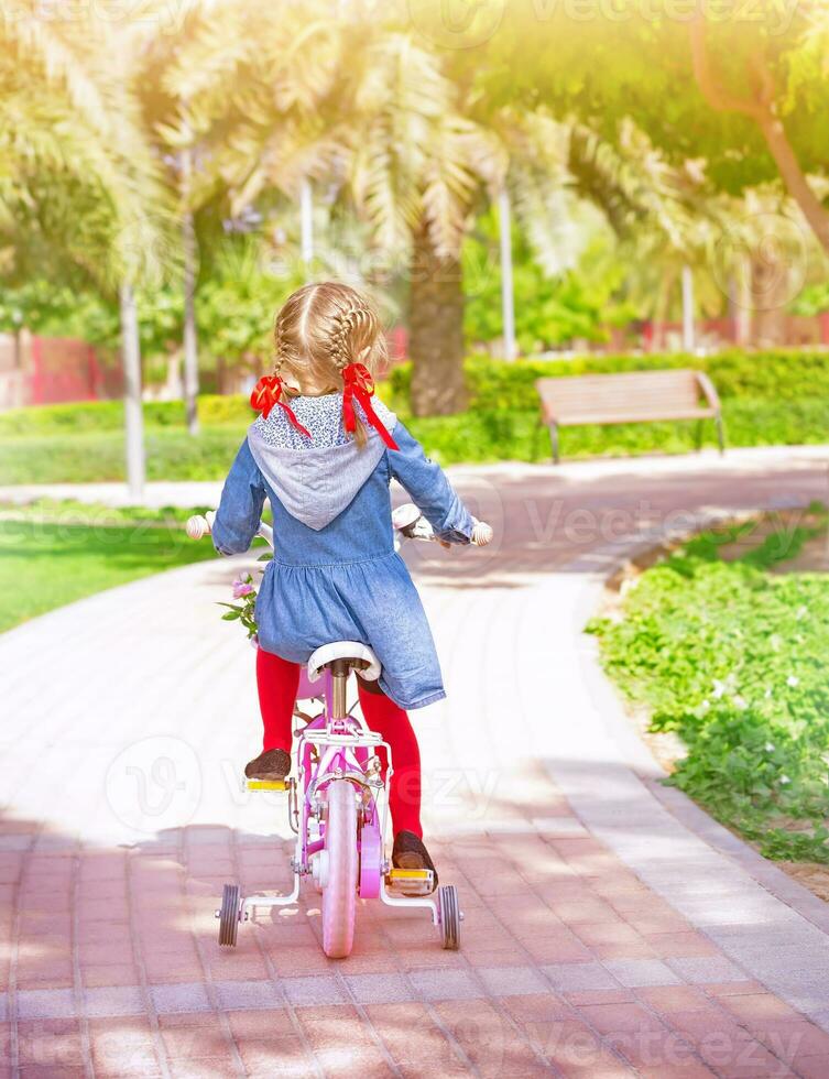 Little girl on the bicycle photo