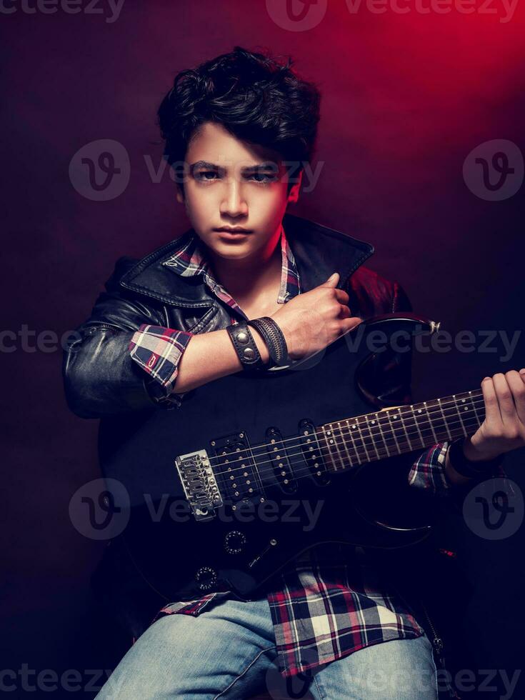 Teen boy with guitar photo