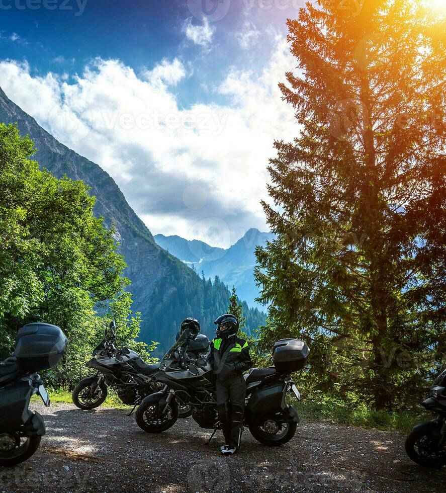 Biker resting in the mountains photo