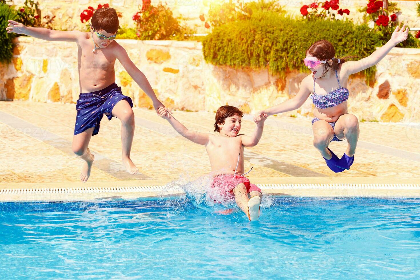 Happy children in the pool photo