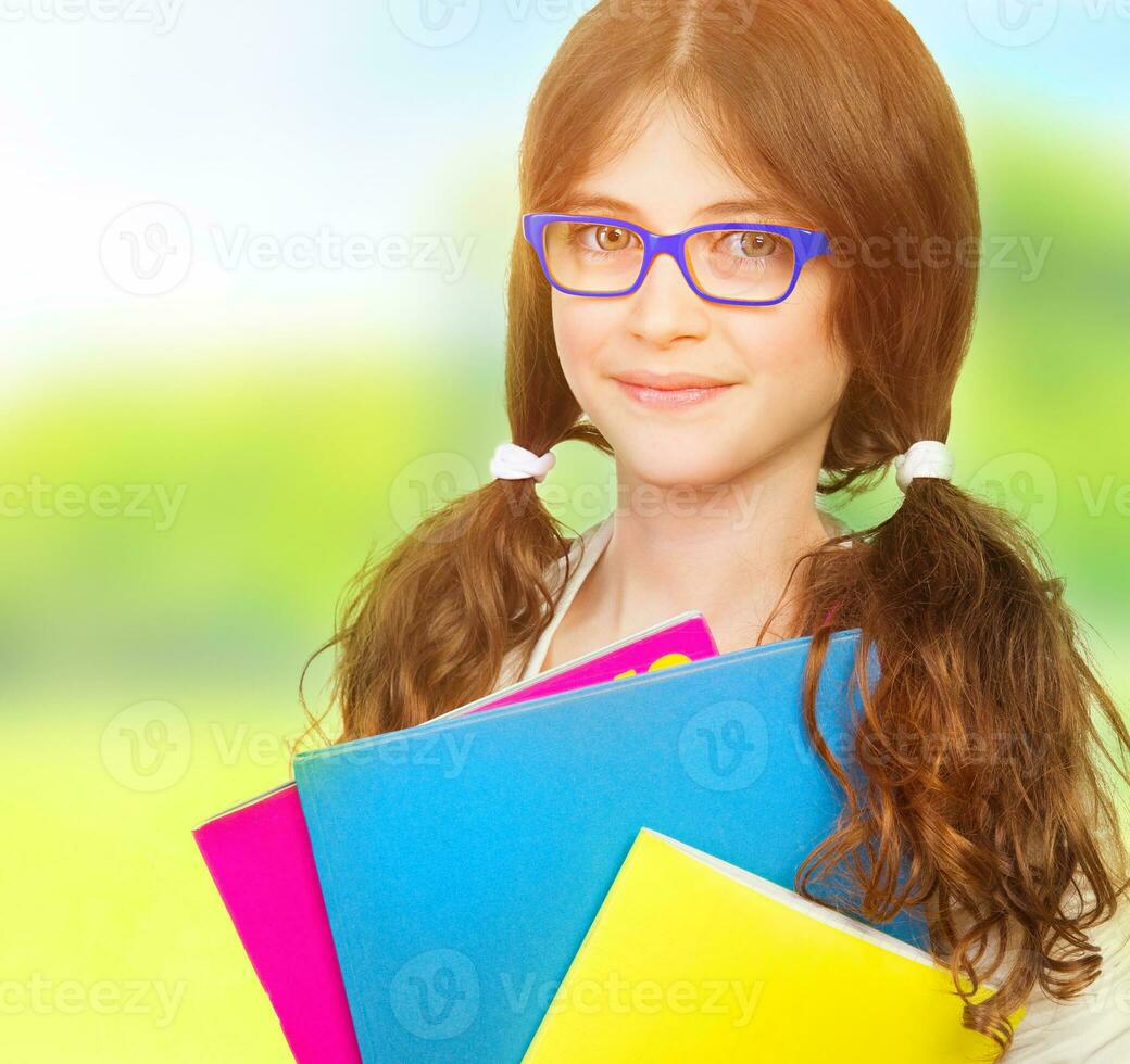 Cute schoolgirl with books photo