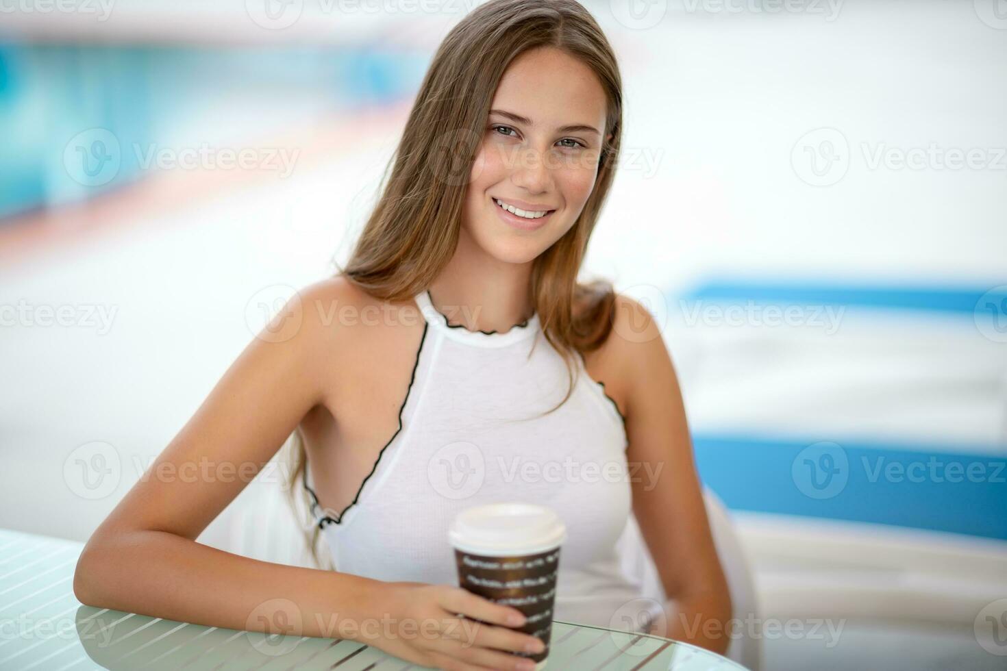 Beautiful woman drinking coffee outdoors photo