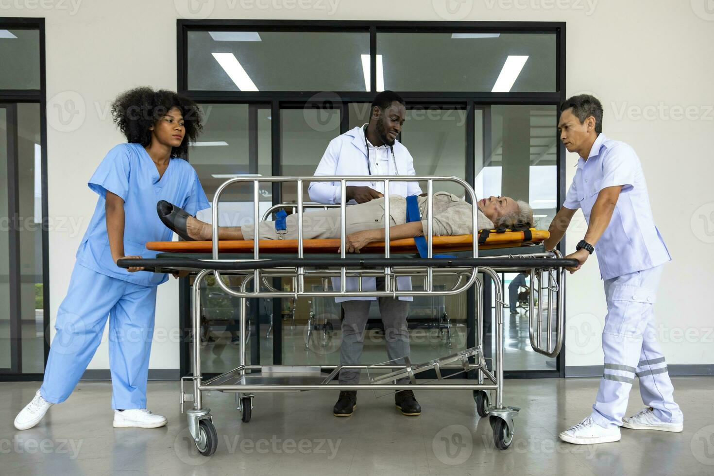 Doctor is guiding the paramedic team to bring patient in bed from car accident into emergency unit in hospital for road accident and heart attack case photo