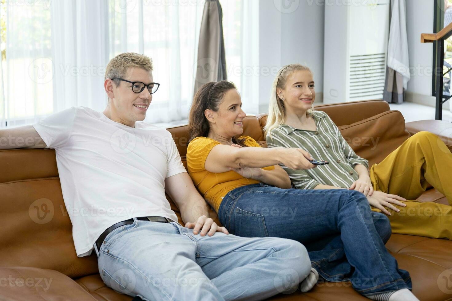 Caucasian friend and family are spending time together watching movie in living room at home for weekend and holiday activities in leisure and happiness photo