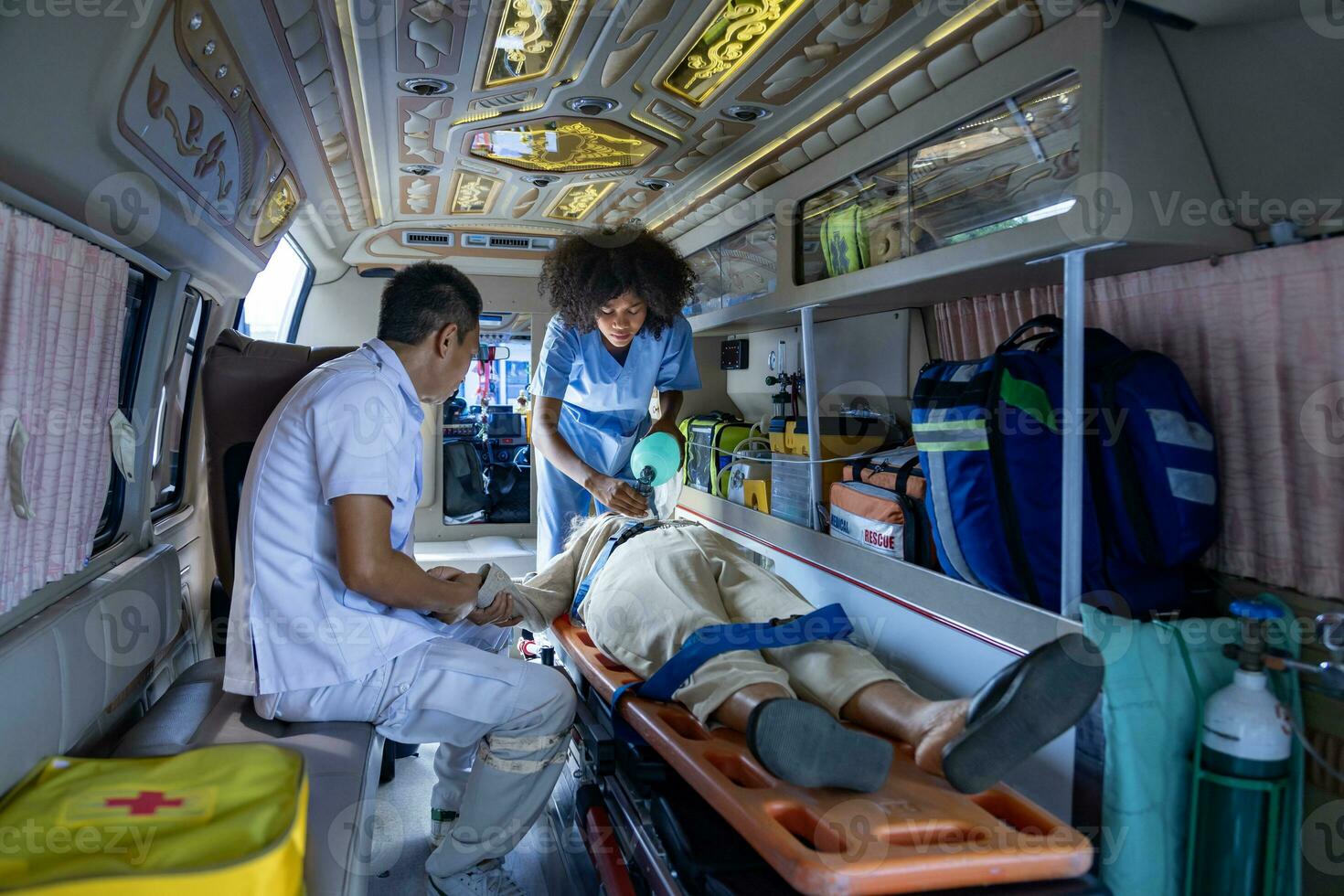 Team of paramedic is helping the senior patient who is stop breathing from car crash by using respirator for heart attack and street accident photo