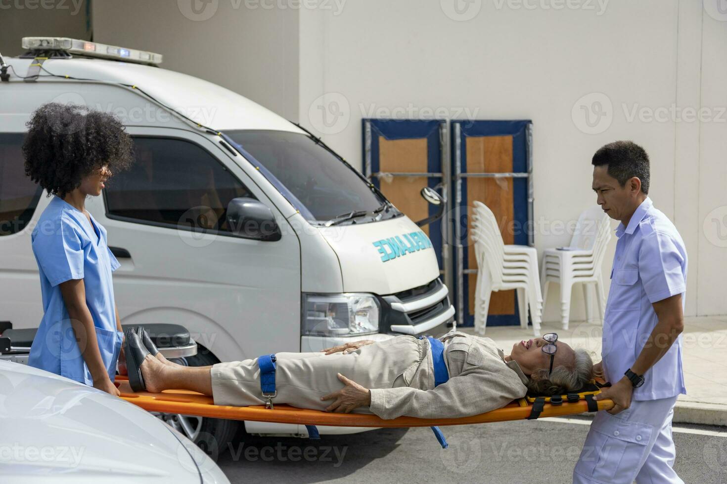 Team of paramedic is helping the senior patient from car crash by using spinal board to transfer into the ambulance for first aid and street accident photo