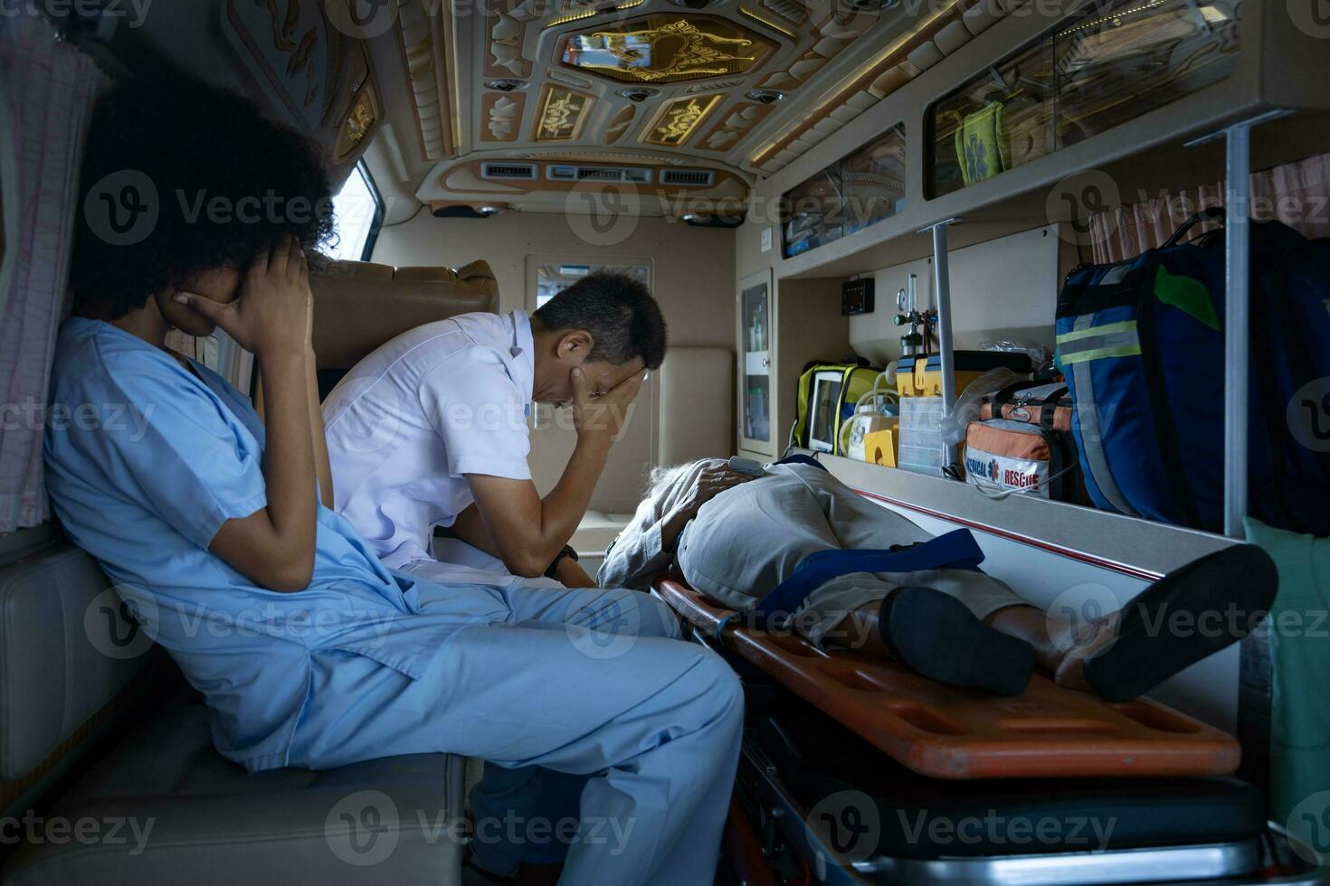 Team of paramedic is sitting in the ambulance in grief as they are too late to save the patient life from car accident for emergency case and unsuccessful life rescue mission photo