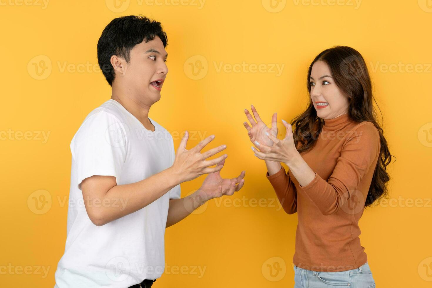 Asian couple arguing on yellow background photo