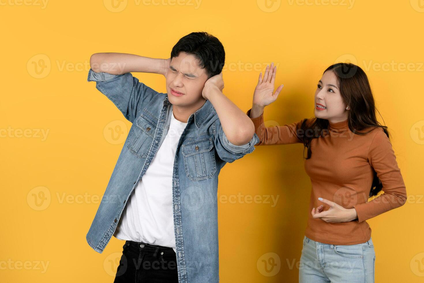 Angry Asian woman shouting at her boyfriend. Couple arguing concept. photo