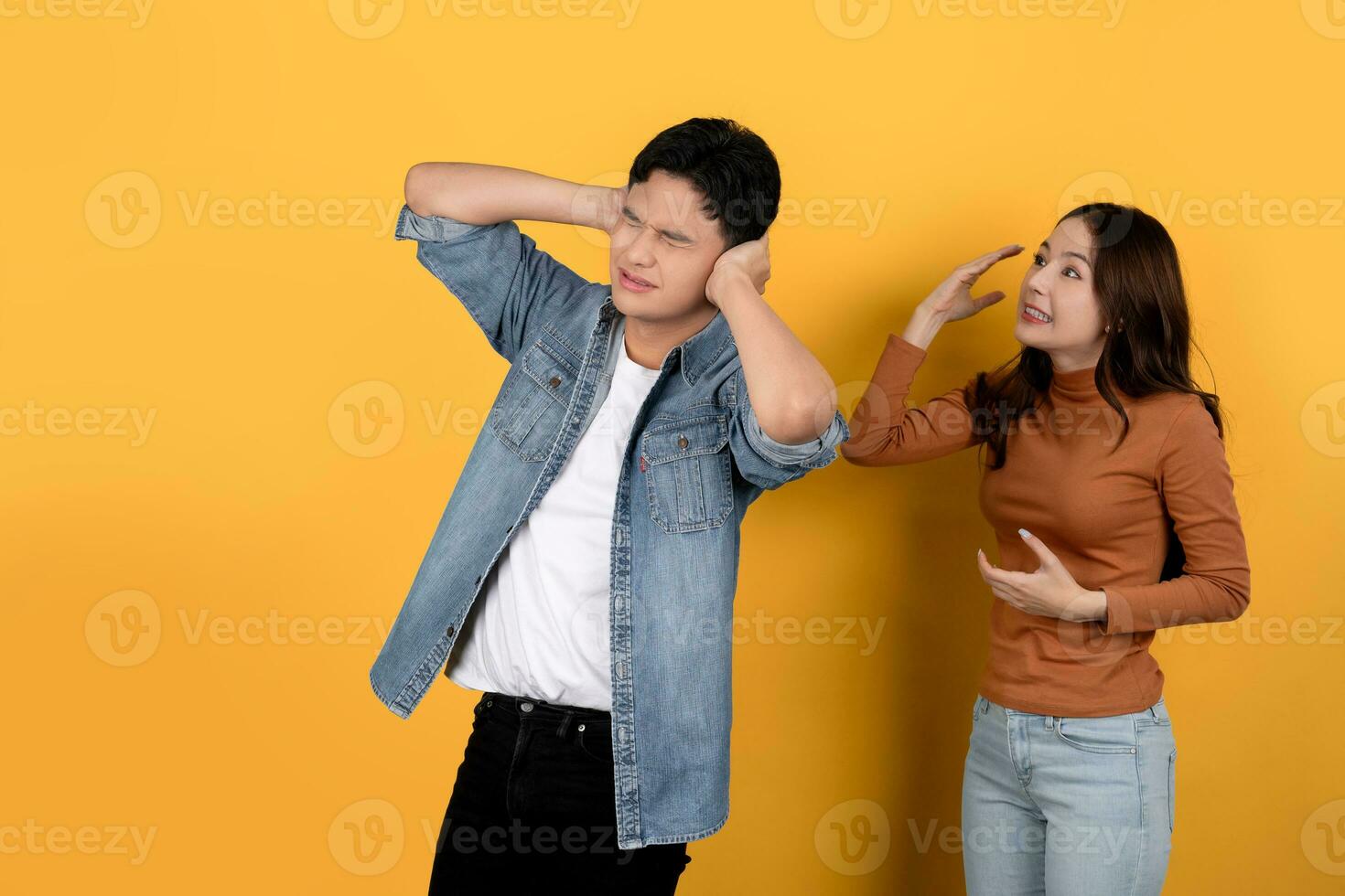 Asian man who is upset while his girlfriend is angry and yelling at him photo