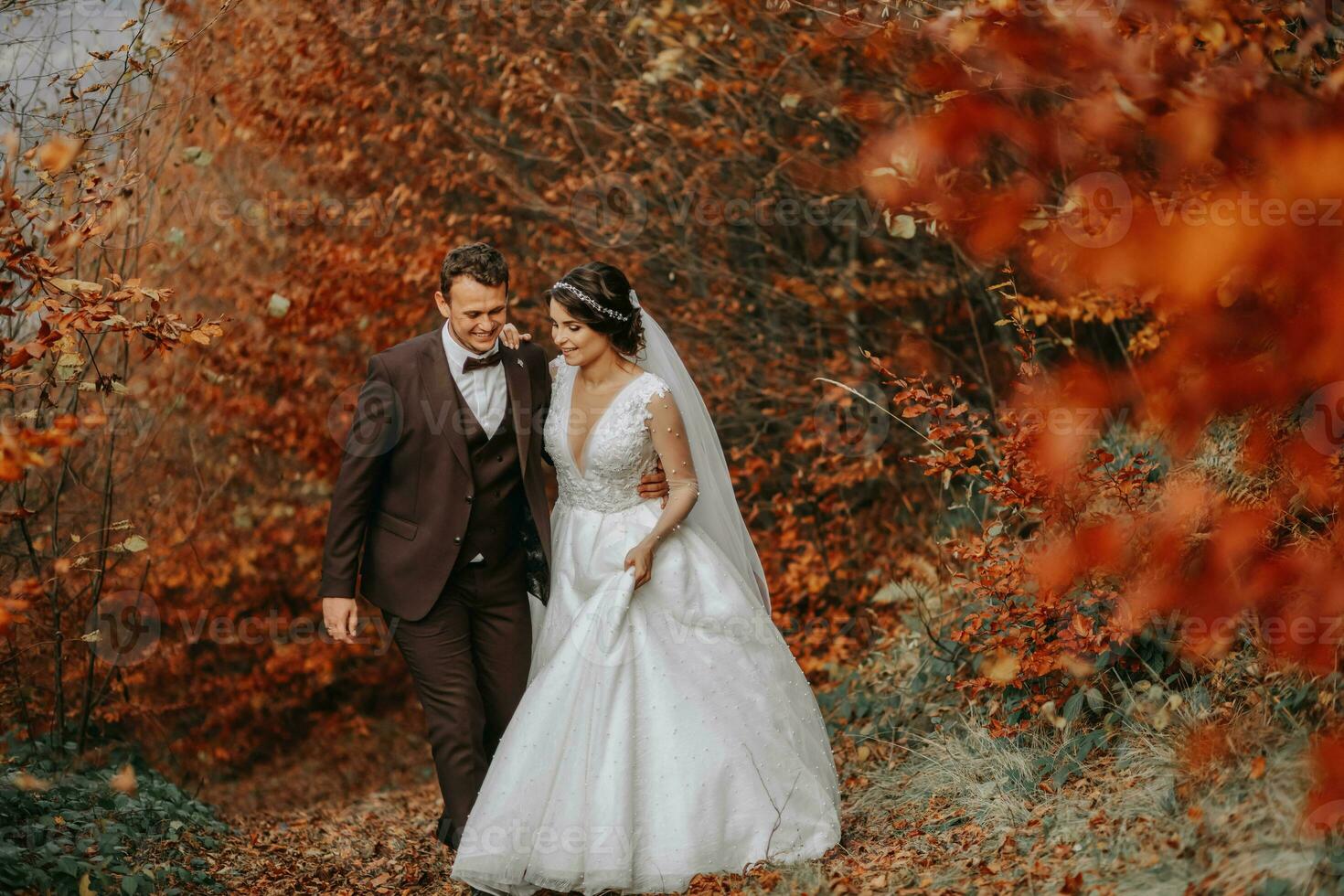 Wedding couple on a walk in the autumn park, medium portrait, place for text photo