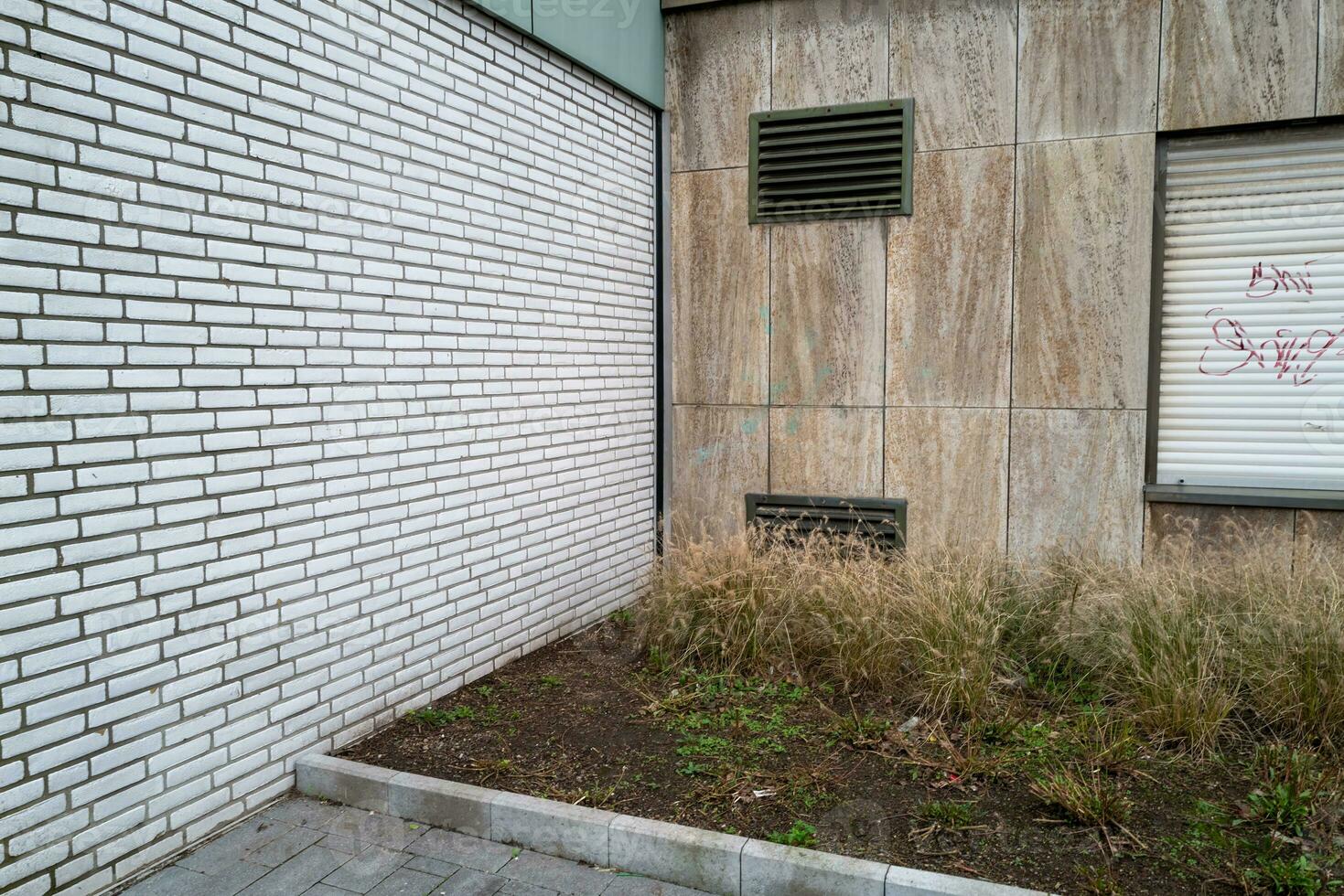 Building with windows and shutters, backyard corner photo