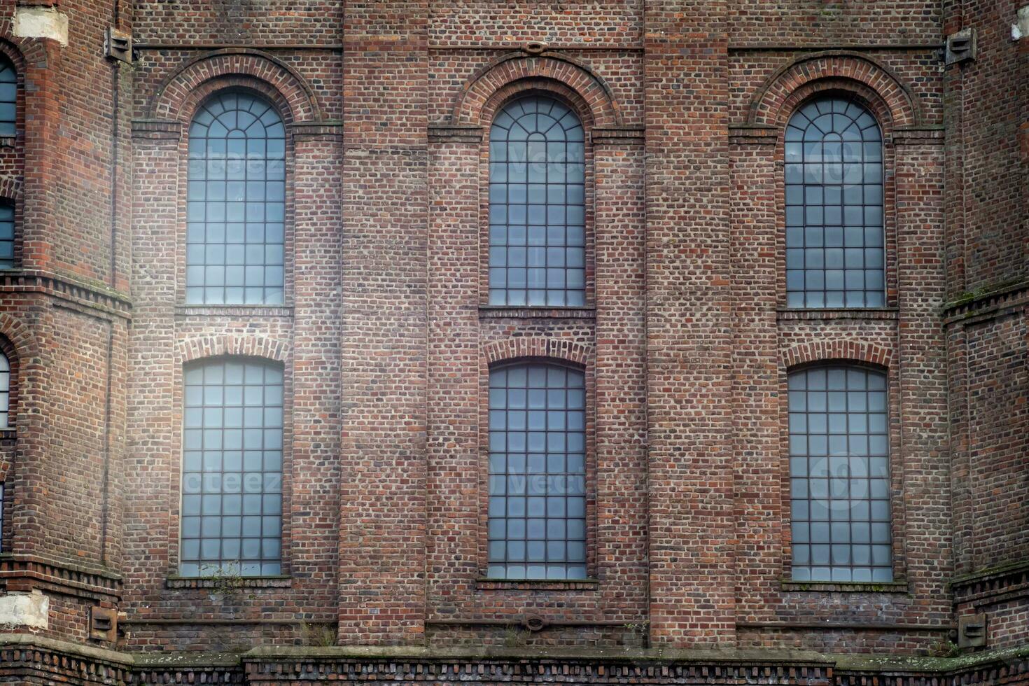 old window in a brick wall of an industrial nearly 100 years old buiding photo