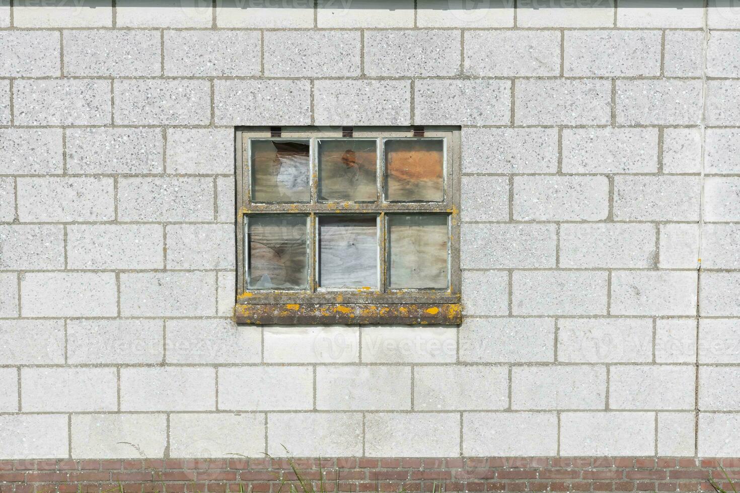 old desolat window on a wall photo