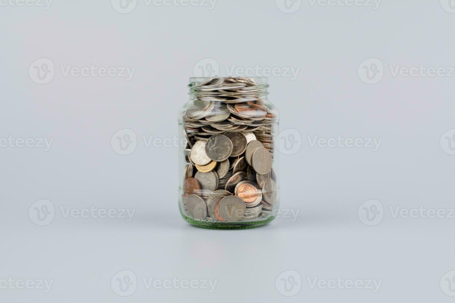 Saving money coins in a glass bottle Concepts of saving money, cash flow, assets and real estate. financial investment coin bank photo