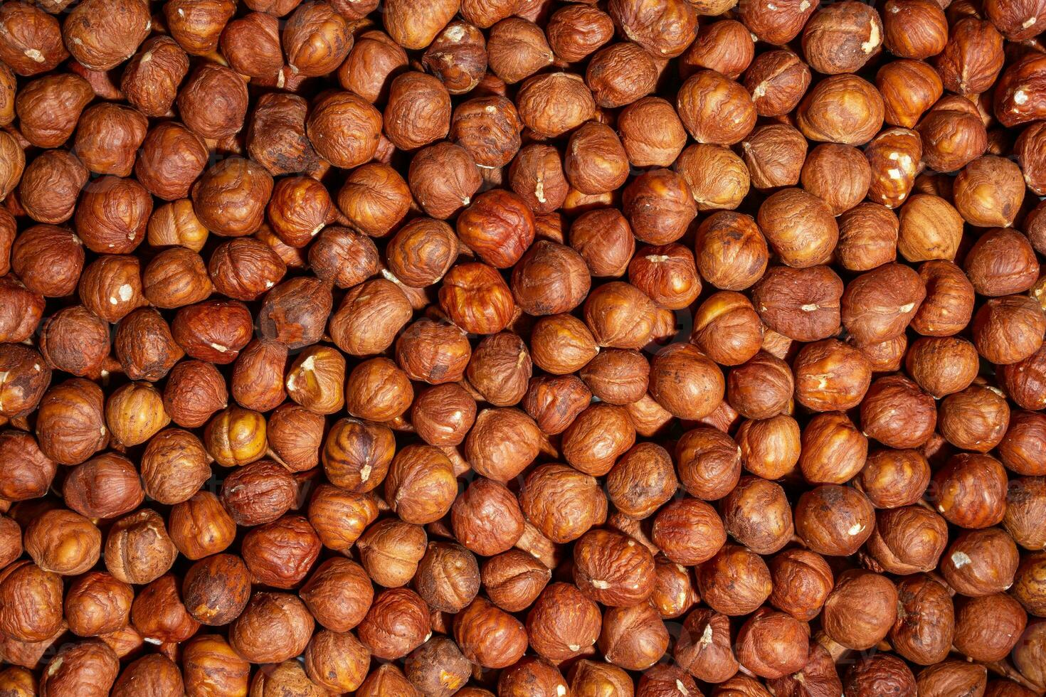 Scattered Peeled Hazelnut - Top View. Background from Hazelnuts. Natural High-Calorie Snacks photo