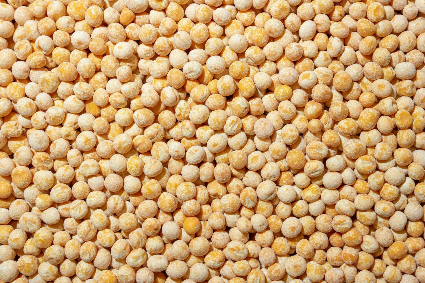 Uncooked Yellow Polished Peas Background. A Culinary Canvas of Dry Yellow Peas, Creating a Lively and Textured Background for Gourmet Cooking. Scattered Raw Polished Peas. Healthy Eating Ingredients photo