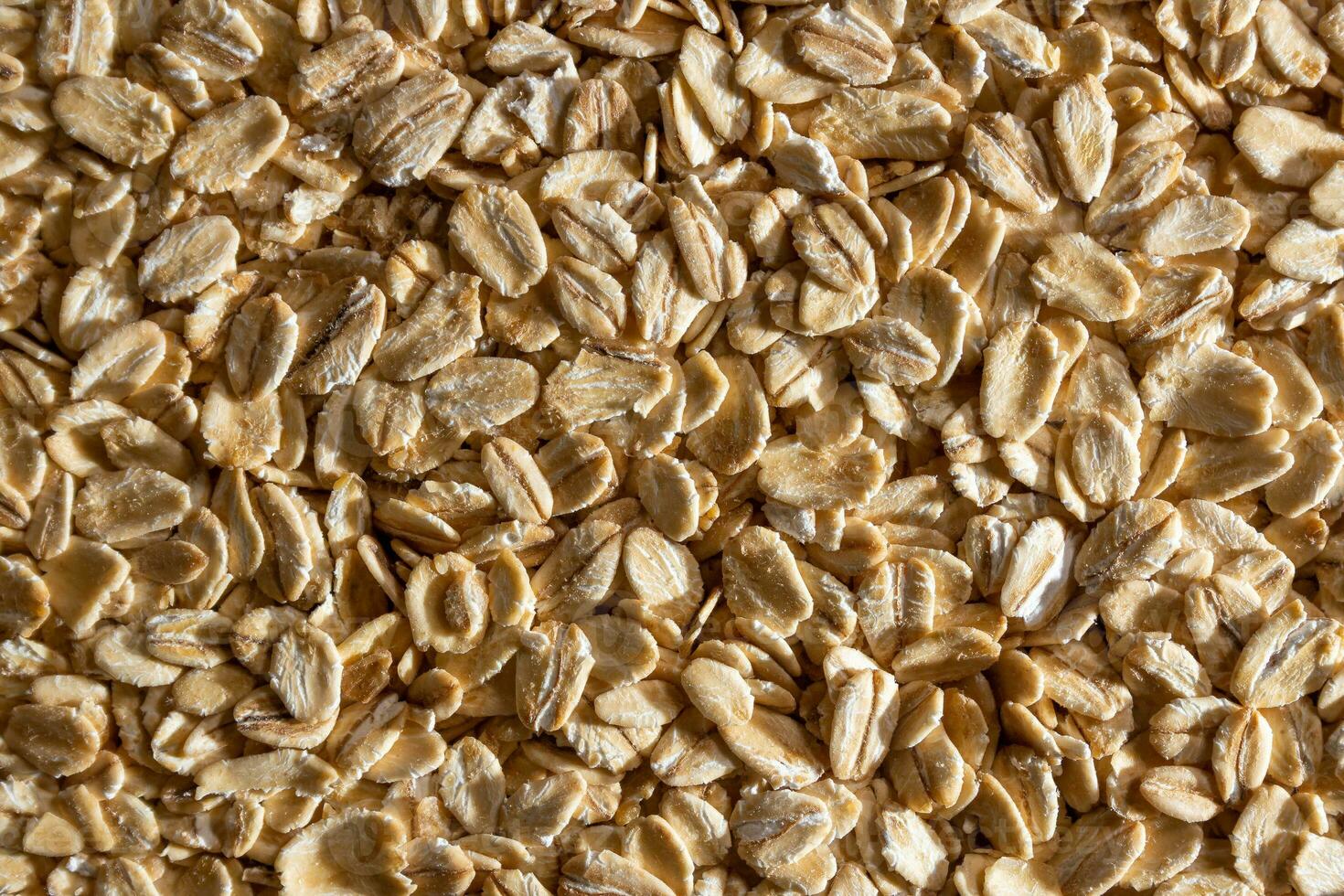 Uncooked Oat Flakes background - Top View, Flat Lay. Scattered Dry and Raw Oat Flakes. Healthy Breakfast and Diet Eating Ingredients photo