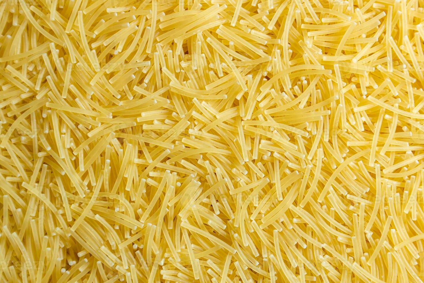 Uncooked Filini Pasta. A Culinary Canvas of Noodles, Creating a Lively and Textured Background for Gourmet Cooking. Dry Pasta. Raw Macaroni - Top View, Flat Lay photo