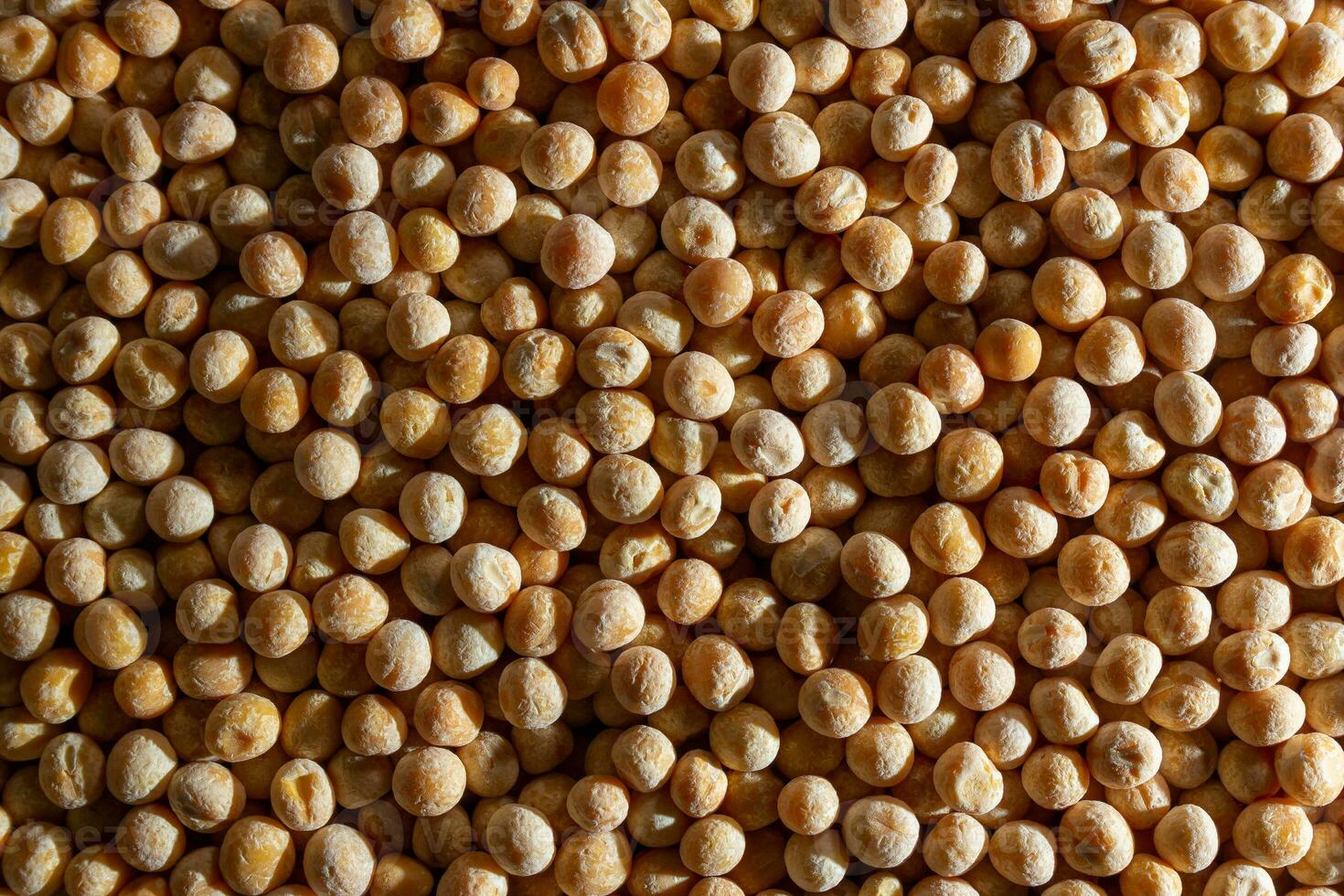 Uncooked Yellow Polished Peas Background. A Culinary Canvas of Dry Yellow Peas, Creating a Lively and Textured Background for Gourmet Cooking. Scattered Raw Polished Peas. Healthy Eating Ingredients photo