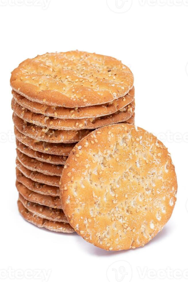 A Stack of Round Salt Crackers with Sesame Isolated on White Background. Dry Snacks - Isolation photo