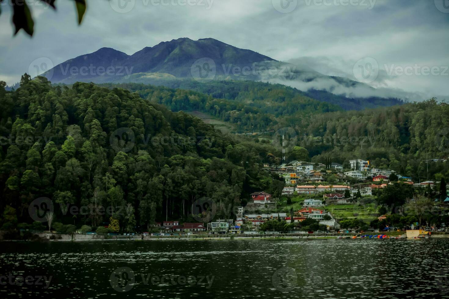 Natural panoramic portrait. Sarangan Lake with fog and boats in the morning. photo