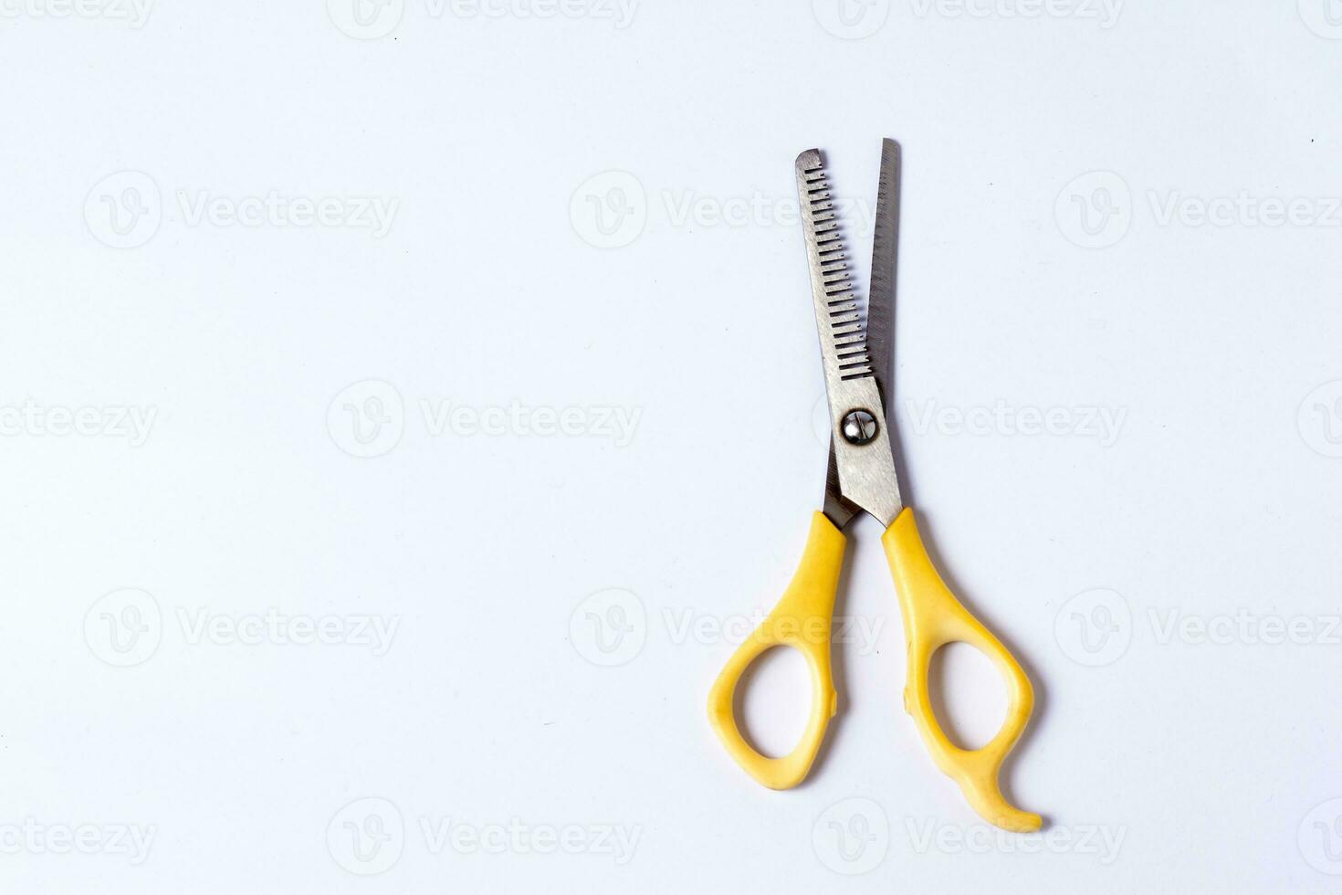 Yellow sasak scissors on a white background photo