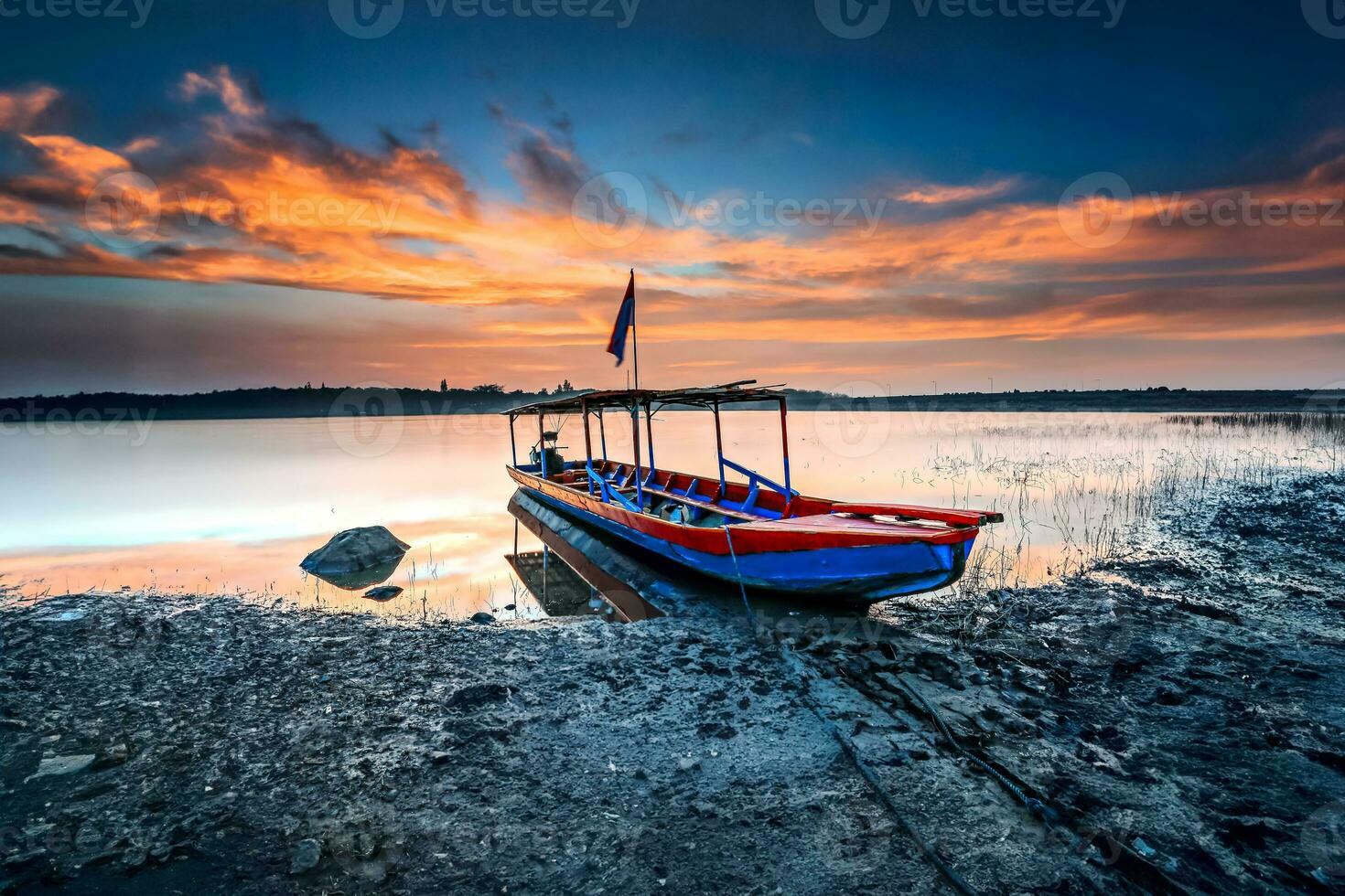 Fishermen on the pier or in shelters with wooden boats dominated by blue lined up and stranded. photo