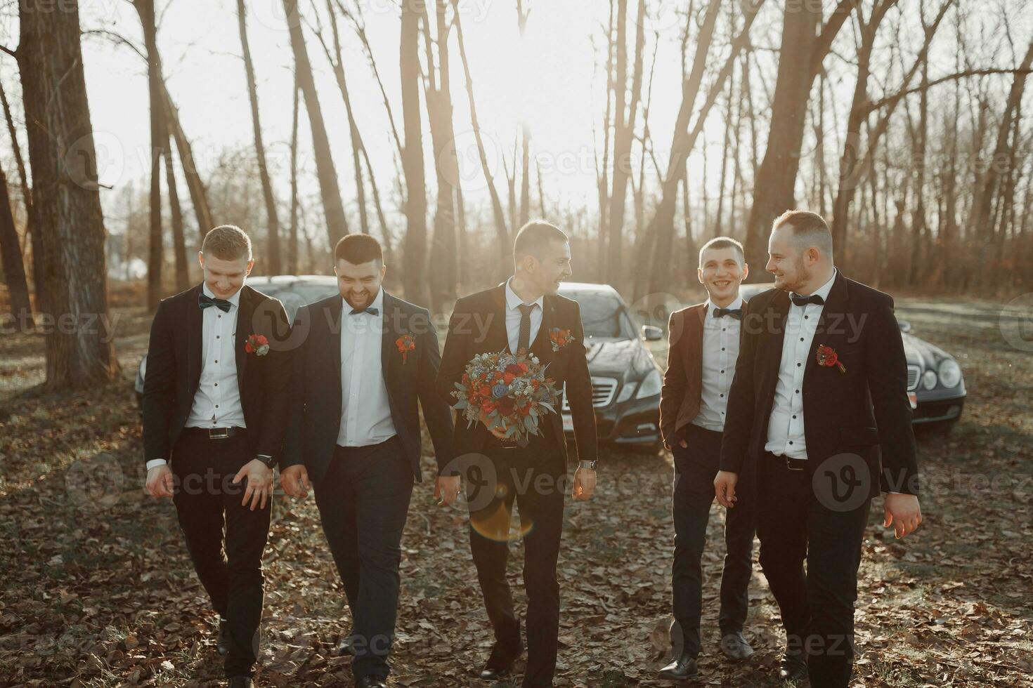 Cheerful, young, energetic witnesses of the groom next to the groom. Friends congratulate the groom. photo