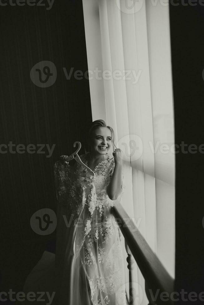 Fashion photo, a beautiful girl in a transparent robe. Fashion, glamor concept. The morning of the bride, the bride in a robe, photo from the front. Black and white photo