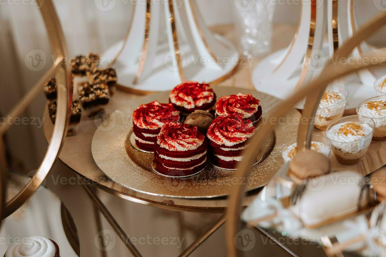 Candy bar. Table with sweets, candies, dessert. cakes and berries in the candy bar. Candy bar with delicious mini cakes, selective focus photo