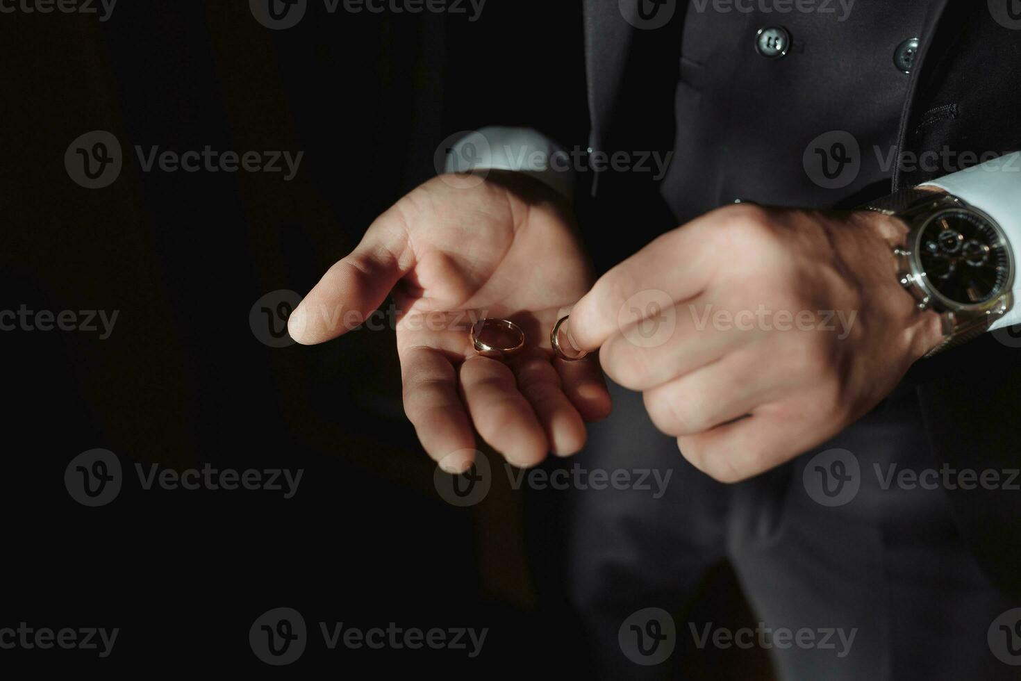 Photo of wedding rings that lie beautifully on the groom's hands. A beautiful photo with details of the wedding. Wedding day. Daylight. A stylish man. Beautiful hands