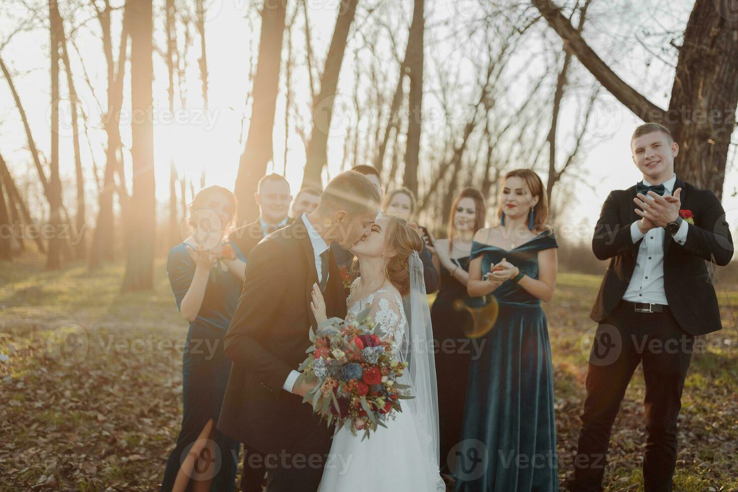 Brides and friends in the nature. Friends at the wedding. Newlywed couple, bridesmaids and groomsmen having fun outdoors photo