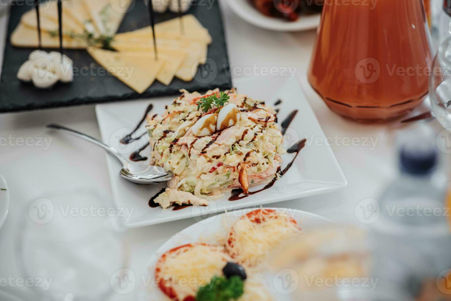 solemn banquet. a buffet table with a lot of delicious snacks. Desserts on a white tablecloth. Cheese snacks. preparation for the celebration photo
