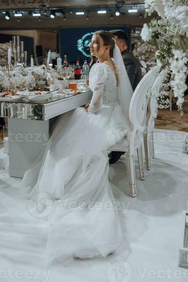 The bride and groom celebrate the wedding in their seats. Everything is almost ready for the wedding ceremony. Wedding banquet photo