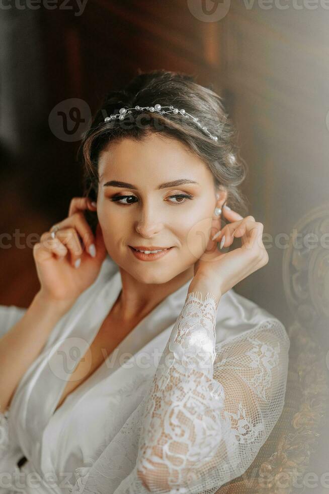 beautiful bride on a retro sofa in a dressing gown with open legs, photo portrait. Wedding hairstyle, light makeup