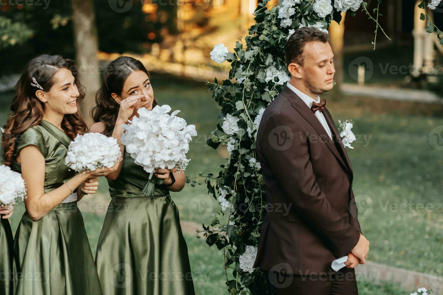 Beautiful wedding couple on the wedding autumn ceremony. the round arch is decorated with white flowers photo