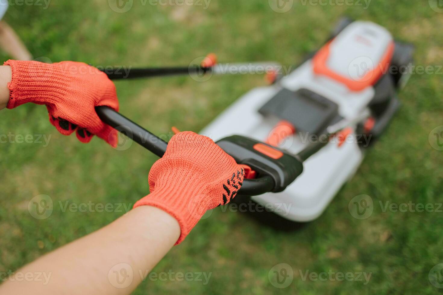 Lawn mover on green grass in modern garden. Machine for cutting lawns. Safety equipment with garden tools photo