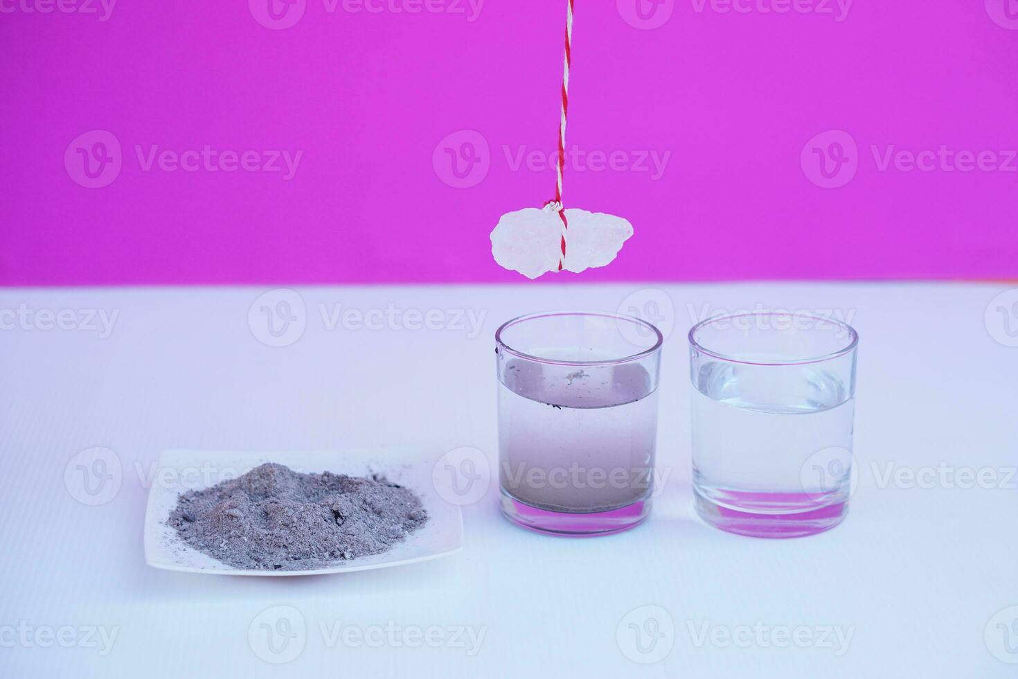 Equipment for doing science experiment about sedimentation by using alum stone with ash water in glass.Concept, Education, Easy activity lesson for kids. Reaction of chemical substance in alum stone. photo