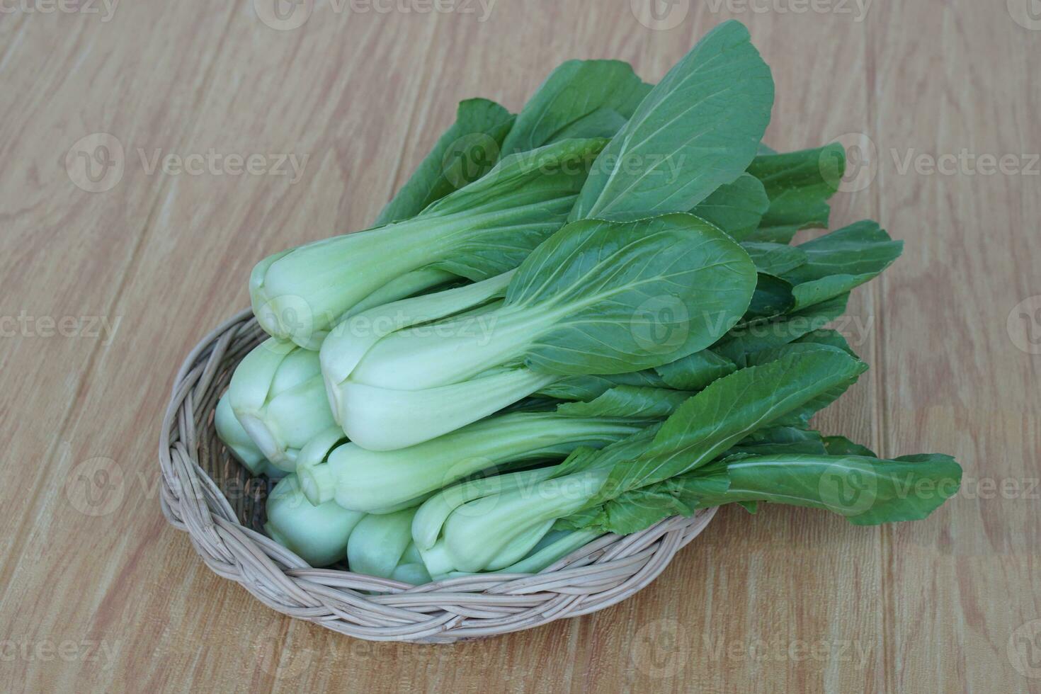 Fresh Bok Choy or Pak Choi or Chinese cabbage on wooden background and in basket for cooking. Concept, Organic vegetables. Healthy food. High fibers and vitamins. photo