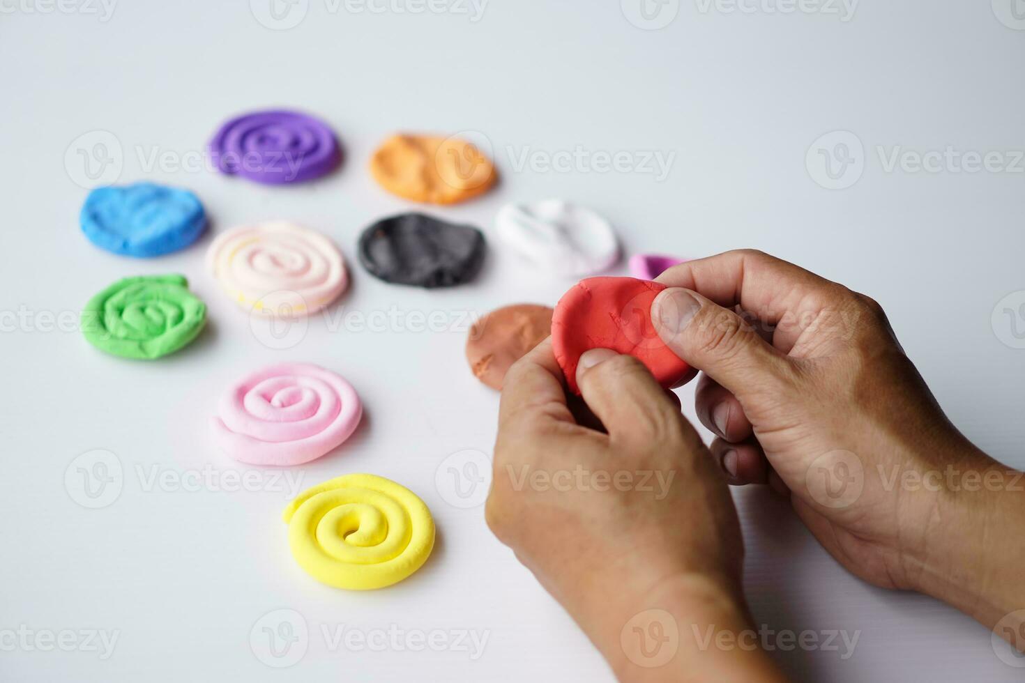 Close up hands sculpt plasticine into different shapes. Concept, alzheimer. weak muscle patients recovering activity by sculpting. Make concentration for ADHD or autistic symptom kids. Enhance imagine photo