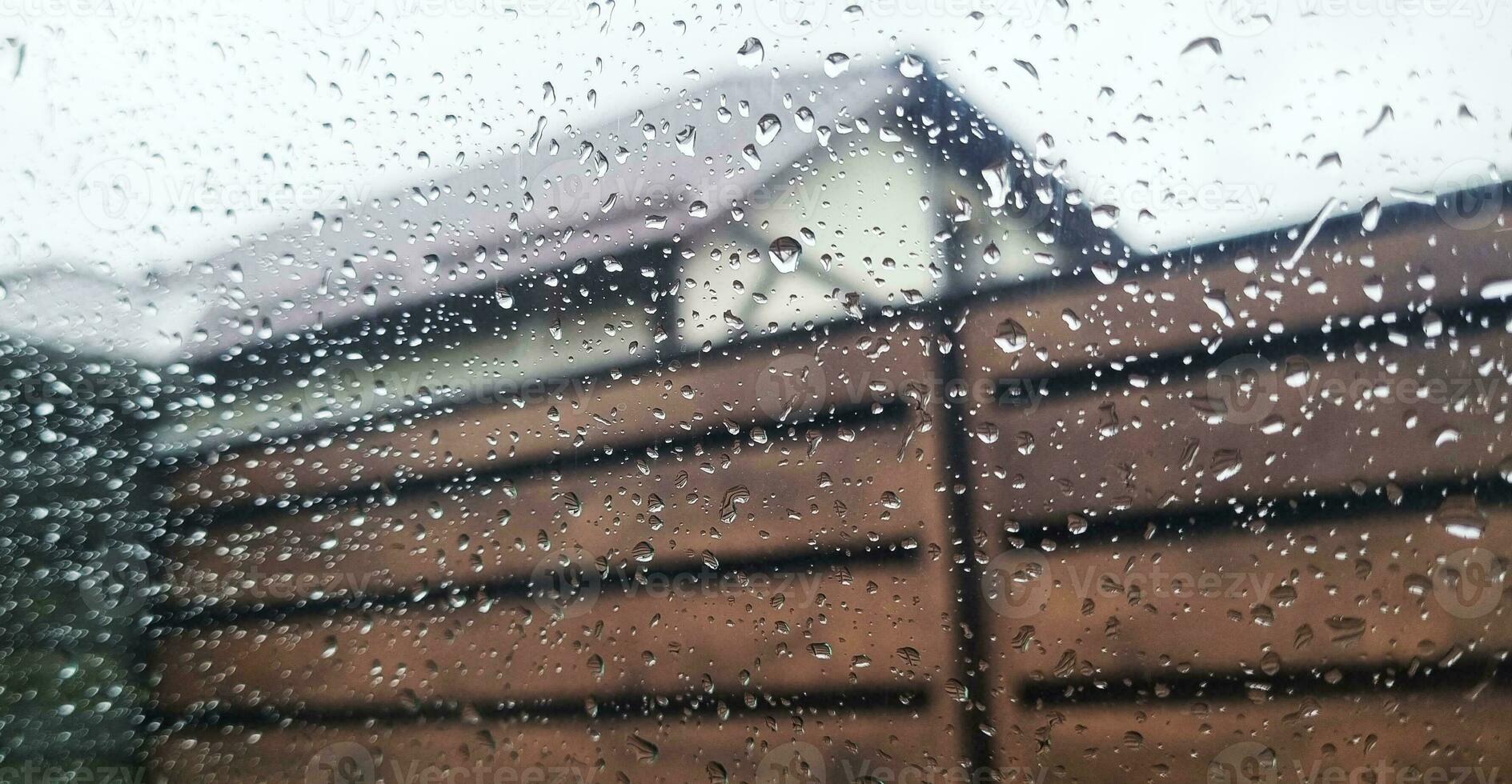 Concept shot of the car window covered by rain drops. Background photo