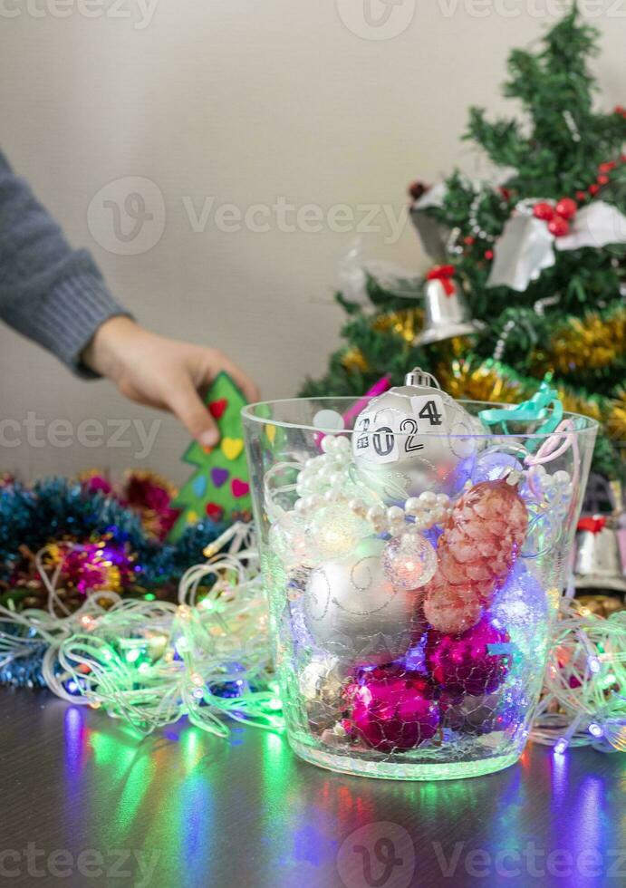 Close up shot of new year decorations. Little boy decorating christmas tree. New year changing numbers. Holiday photo