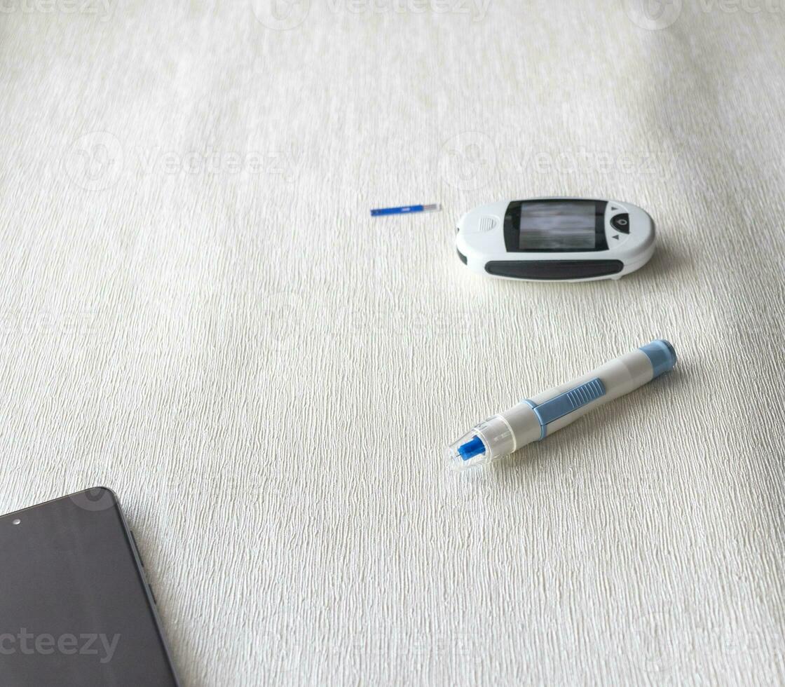 Close up shot of the glucometer instrument on the white surface. Healthcare photo