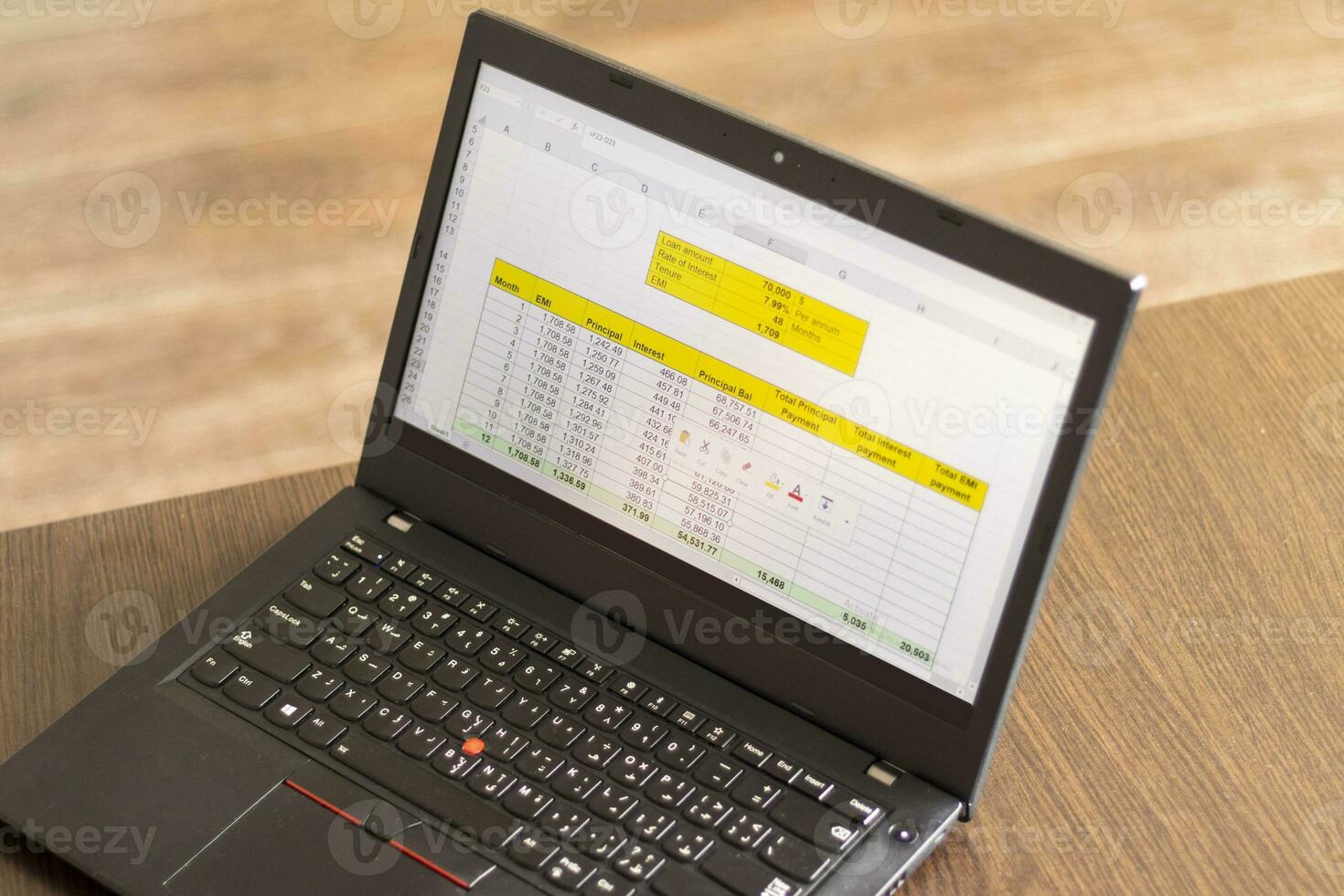 Laptop showing an excel sheet on the screen with bank loan amortization table. Finance photo